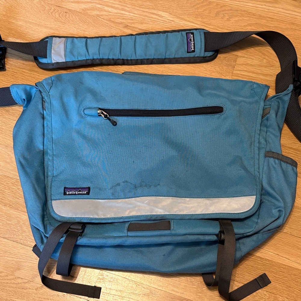 Patagonia Teal Blue Messenger Bag with Reflective Trim stains shoulder laptop